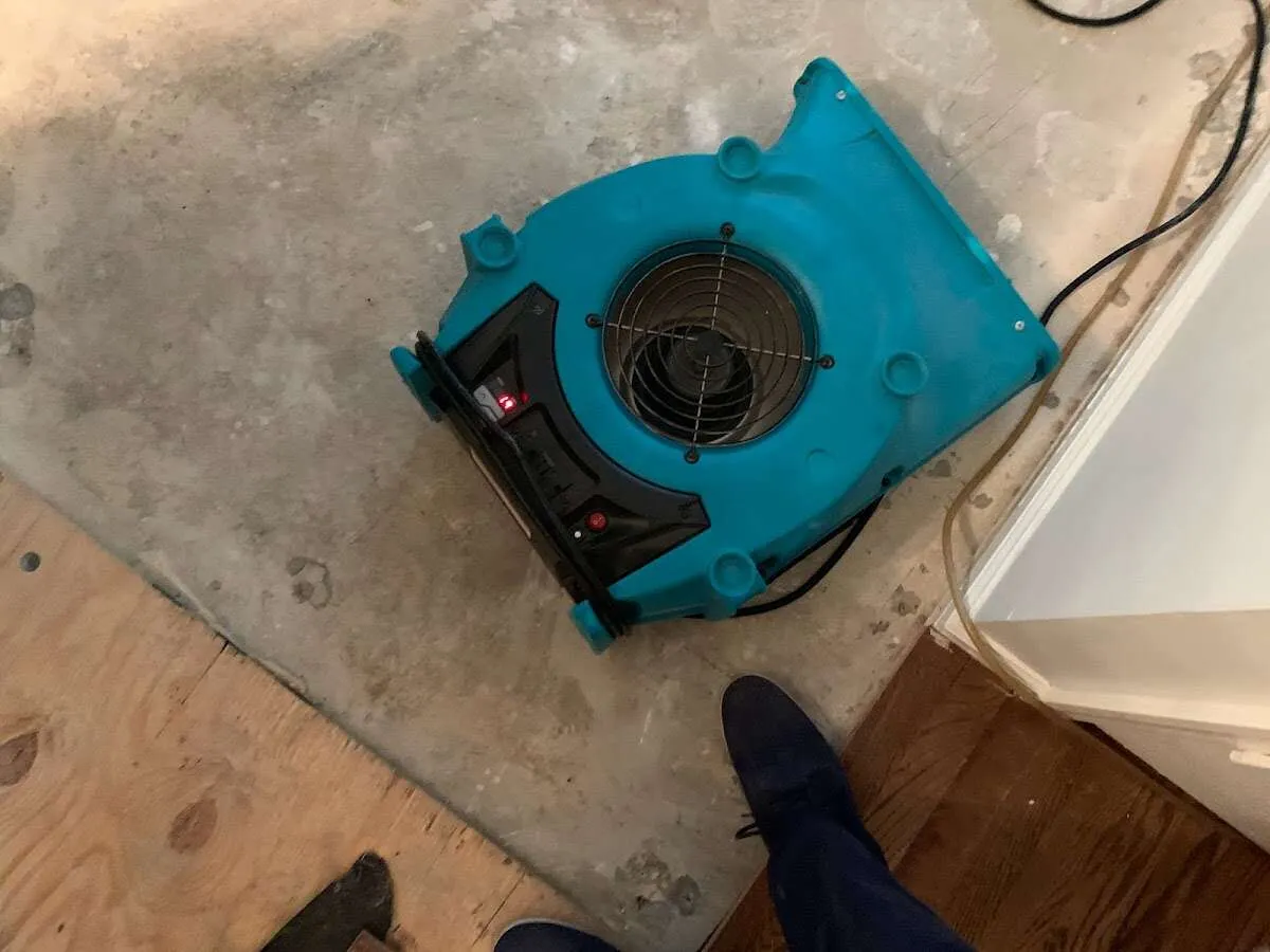 Air mover drying subfloor during Commercial Water Damage Restoration in Montecito
